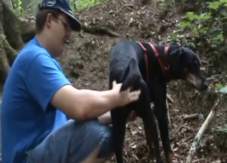 Black dog gets fingered by a kinky dude in blue